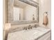 Stylish bathroom features a granite countertop and unique decorative mirror at 8713 Nautical Bay Ln, Las Vegas, NV 89117