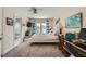 Comfortable bedroom with a ceiling fan, and balcony access, adjacent to an ensuite bathroom at 8713 Nautical Bay Ln, Las Vegas, NV 89117