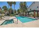 Community pool and spa with lounge chairs and covered seating area at 8713 Nautical Bay Ln, Las Vegas, NV 89117