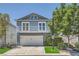 Charming blue two-story home featuring a garage and a balcony at 8713 Nautical Bay Ln, Las Vegas, NV 89117