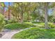 Beautifully landscaped grounds featuring mature trees, manicured lawns, and walking paths at 8713 Nautical Bay Ln, Las Vegas, NV 89117
