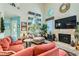 Cozy living room featuring a fireplace and comfortable seating with large windows at 8713 Nautical Bay Ln, Las Vegas, NV 89117