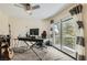 Bright home office with a large desk, ergonomic chair, and balcony access overlooking the backyard at 8713 Nautical Bay Ln, Las Vegas, NV 89117