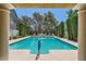 Inviting community pool area framed by pillars and lush landscaping, creating a serene atmosphere at 8713 Nautical Bay Ln, Las Vegas, NV 89117
