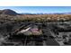 Aerial shot of a home displaying its well-maintained exterior and surroundings in a desirable neighborhood with mountain views at 9077 Creed Mountain Pl, Las Vegas, NV 89178
