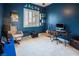 Bedroom with blue walls, a guitar, and a desk at 9077 Creed Mountain Pl, Las Vegas, NV 89178