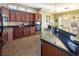 Open kitchen layout featuring wood cabinets, granite counters, and stainless appliances at 9077 Creed Mountain Pl, Las Vegas, NV 89178