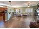 Open-concept living space with kitchen, dining area, a fireplace and comfortable seating at 9077 Creed Mountain Pl, Las Vegas, NV 89178
