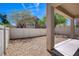 Backyard with rocks, concrete patio, a pillar, and a view to a two-story home at 10062 Aspen Rose St # 103, Las Vegas, NV 89183