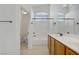 Bright bathroom with a shower-tub combo and double sinks with wood cabinets at 10062 Aspen Rose St # 103, Las Vegas, NV 89183