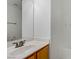 Bright bathroom featuring a white sink, wood cabinets, a large mirror and a shower at 10062 Aspen Rose St # 103, Las Vegas, NV 89183