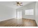 Sunlit bedroom with wood-look floors, white walls, and a ceiling fan at 10062 Aspen Rose St # 103, Las Vegas, NV 89183