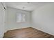 Bright bedroom with wood-look floors, a window with blinds, and a closet with sliding doors at 10062 Aspen Rose St # 103, Las Vegas, NV 89183
