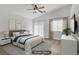Relaxing primary bedroom with a ceiling fan and a large window provides ample natural light at 10062 Aspen Rose St # 103, Las Vegas, NV 89183