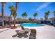 Resort-style community pool area with lounge chairs and palm trees at 10062 Aspen Rose St # 103, Las Vegas, NV 89183