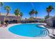 Inviting community pool with sun loungers and shady palm trees at 10062 Aspen Rose St # 103, Las Vegas, NV 89183