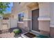 Inviting front entry with a cozy welcome mat and well-maintained landscaping at 10062 Aspen Rose St # 103, Las Vegas, NV 89183