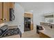 Well-equipped kitchen featuring modern appliances, gas range, adjacent to the dining space at 10062 Aspen Rose St # 103, Las Vegas, NV 89183
