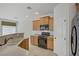 Bright kitchen with black appliances and lots of storage overlooking the living space at 10062 Aspen Rose St # 103, Las Vegas, NV 89183