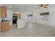 Open kitchen featuring granite countertops, black appliances and seamless flow into the living room at 10062 Aspen Rose St # 103, Las Vegas, NV 89183