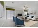 Bright, staged living room features stylish seating, a ceiling fan and a sliding glass door at 10062 Aspen Rose St # 103, Las Vegas, NV 89183