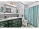 Clean bathroom with updated vanity, modern sink, and shower with blue tile at 10654 Sidlaw Hills Ct, Las Vegas, NV 89141