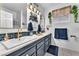 Stylish bathroom features double sinks, white counters and chic lighting fixtures at 10654 Sidlaw Hills Ct, Las Vegas, NV 89141