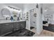 Bathroom featuring dual sinks, modern vanities, and access to the bedroom at 10654 Sidlaw Hills Ct, Las Vegas, NV 89141