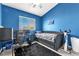 This bedroom has a twin-sized bed and a home office with bright blue walls at 10654 Sidlaw Hills Ct, Las Vegas, NV 89141