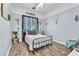 Cozy bedroom boasts a comfortable bed, wood-look floors, and ample natural light at 10654 Sidlaw Hills Ct, Las Vegas, NV 89141