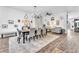 Open dining area featuring a long table with seating, modern decorations, and a seamless flow to the living space at 10654 Sidlaw Hills Ct, Las Vegas, NV 89141