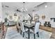 Bright dining area with a table, chairs, and decor connecting seamlessly with the staircase at 10654 Sidlaw Hills Ct, Las Vegas, NV 89141