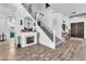 Bright foyer showcases a staircase, fireplace, and wood-look floors creating an inviting entrance at 10654 Sidlaw Hills Ct, Las Vegas, NV 89141