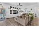 Bright living room featuring wood floors, large built-in entertainment center, and access to the backyard pool at 10654 Sidlaw Hills Ct, Las Vegas, NV 89141