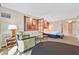 Cozy suite featuring a sitting area with a sofa, chair, and a comfortable bed at 135 E Harmon Ave # 2303, Las Vegas, NV 89109