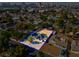 An aerial view shows the home's solar panels and fenced yard within a vibrant neighborhood at 1411 Norman Ave, Las Vegas, NV 89104