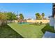 Expansive backyard with a sparkling pool, lounge chairs, and a seating area under mature trees at 1411 Norman Ave, Las Vegas, NV 89104