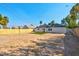 The spacious backyard includes a small patch of artificial turf and a wooden fence, offering potential for landscaping and outdoor activities at 1411 Norman Ave, Las Vegas, NV 89104