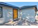 Charming home featuring a bright yellow front door and modern solar panels at 1411 Norman Ave, Las Vegas, NV 89104