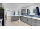 Modern kitchen with gray cabinets, stainless appliances, island and blue backsplash at 1411 Norman Ave, Las Vegas, NV 89104