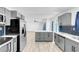 Modern kitchen with gray cabinets, stainless appliances, and an island with white countertop at 1411 Norman Ave, Las Vegas, NV 89104