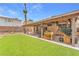 Cozy covered patio opens onto lush backyard and desert landscaping, perfect for outdoor living at 1468 Harmony Hill Dr, Henderson, NV 89014