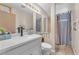 Bright bathroom featuring a modern vanity, stylish mirror, and tiled shower at 1468 Harmony Hill Dr, Henderson, NV 89014