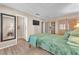 Comfortable bedroom with wood-look floors, neutral walls, and ensuite bathroom at 1468 Harmony Hill Dr, Henderson, NV 89014