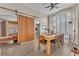 Dining room featuring sliding barn door, wood laminate flooring, and large window at 1468 Harmony Hill Dr, Henderson, NV 89014