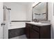 Bathroom with an undermount sink, tub and shower, and dark wood cabinets at 1609 Hills Of Red Dr # 104, Las Vegas, NV 89128