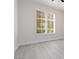 Bedroom with wood-look flooring and a window with shutter-style blinds at 1609 Hills Of Red Dr # 104, Las Vegas, NV 89128