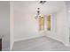 Bright dining area with an ornate chandelier and shuttered windows at 1609 Hills Of Red Dr # 104, Las Vegas, NV 89128