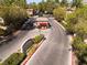 Redhills community entrance featuring a gatehouse, signage, and well-maintained landscaping at 1609 Hills Of Red Dr # 104, Las Vegas, NV 89128