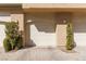 Attached garage featuring white door, neutral siding and paver driveway with landscaping at 1609 Hills Of Red Dr # 104, Las Vegas, NV 89128